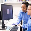 Two people working at the computer