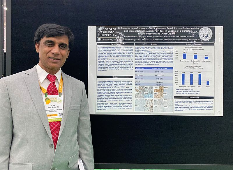 Rafiq Shahid standing with his presentation poster